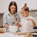 mother-with-daughter-preparing-dough-baking.webp