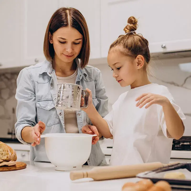 mother-with-daughter-preparing-dough-baking (1).webp